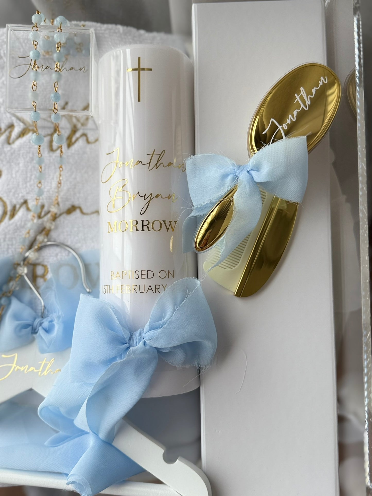 Christening keepsake box with rosary, holy water bottle and candle
